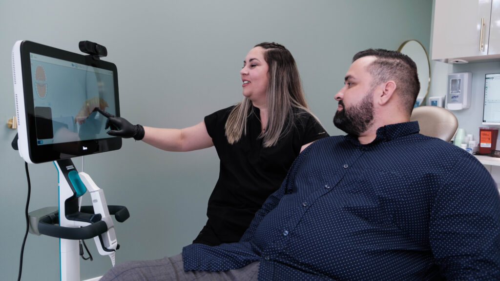 A man smiles during a dental consultation at SP Smile Dentistry.