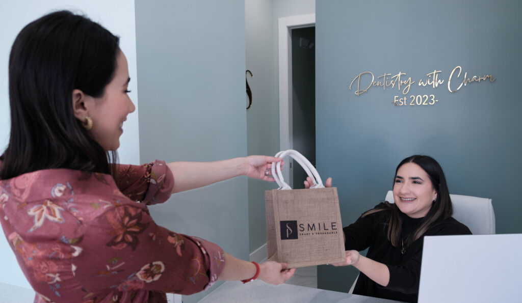 A patient smiling while receiving a dental consultation at SP Smile Dentistry.