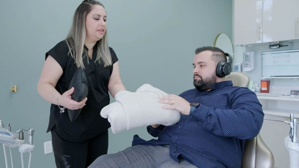 Dental assistant comforting patient at SP Smile Dentistry