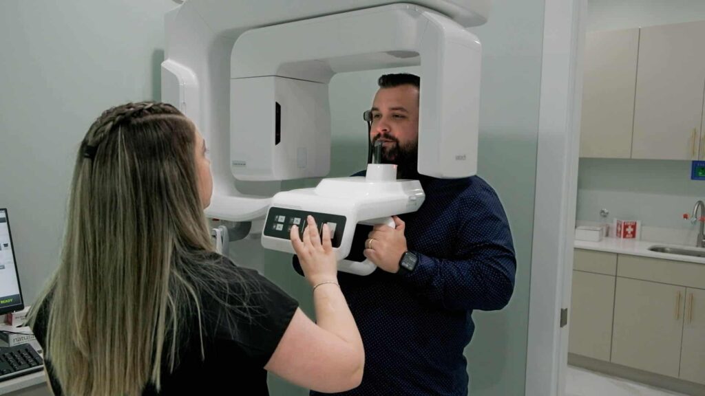 modern technology x-ray machine at SP Smile with male patient and dental assistant