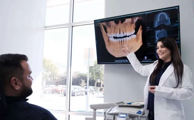 La Dra. Susel Pérez habla sobre las radiografías con un paciente en SP Smile, considerado uno de los mejores dentistas cerca de mí en la zona de Miami (Florida).